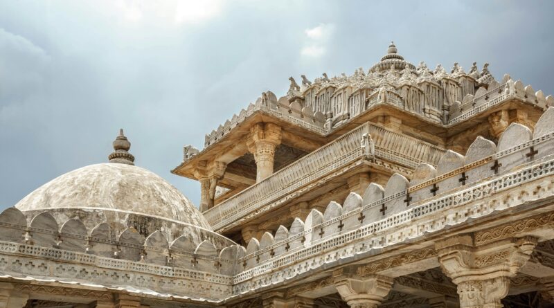 Stunning view of the intricate carvings on the Ranakpur Jain Temple in Rajasthan, India, under a cloudy sky.